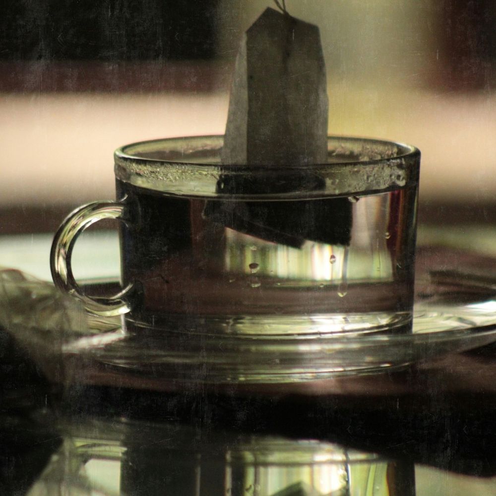 peppermint tea in a glass cup with dark background. this is because peppertea is the basis for the ACV hair rinse.
