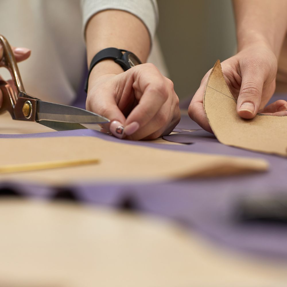 cutting out a leather and cotton tote bag