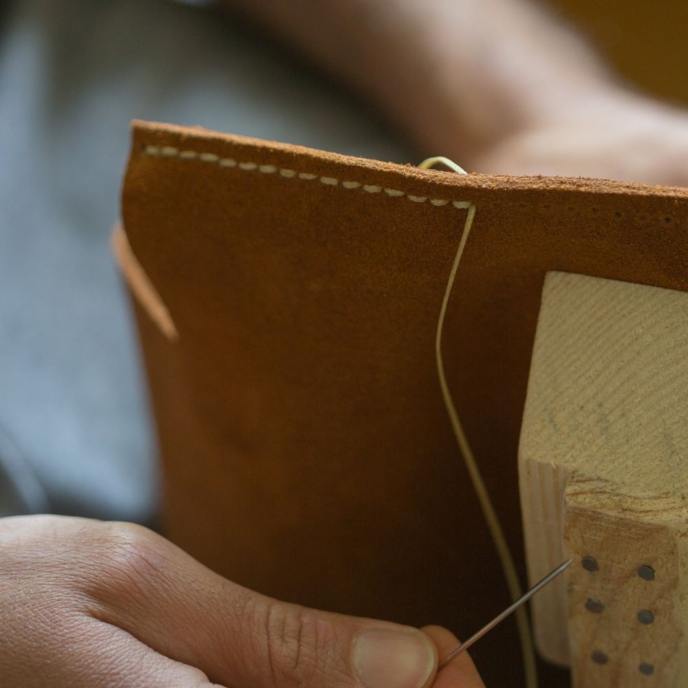 hand stitching leather using a donkey for made in the Glen