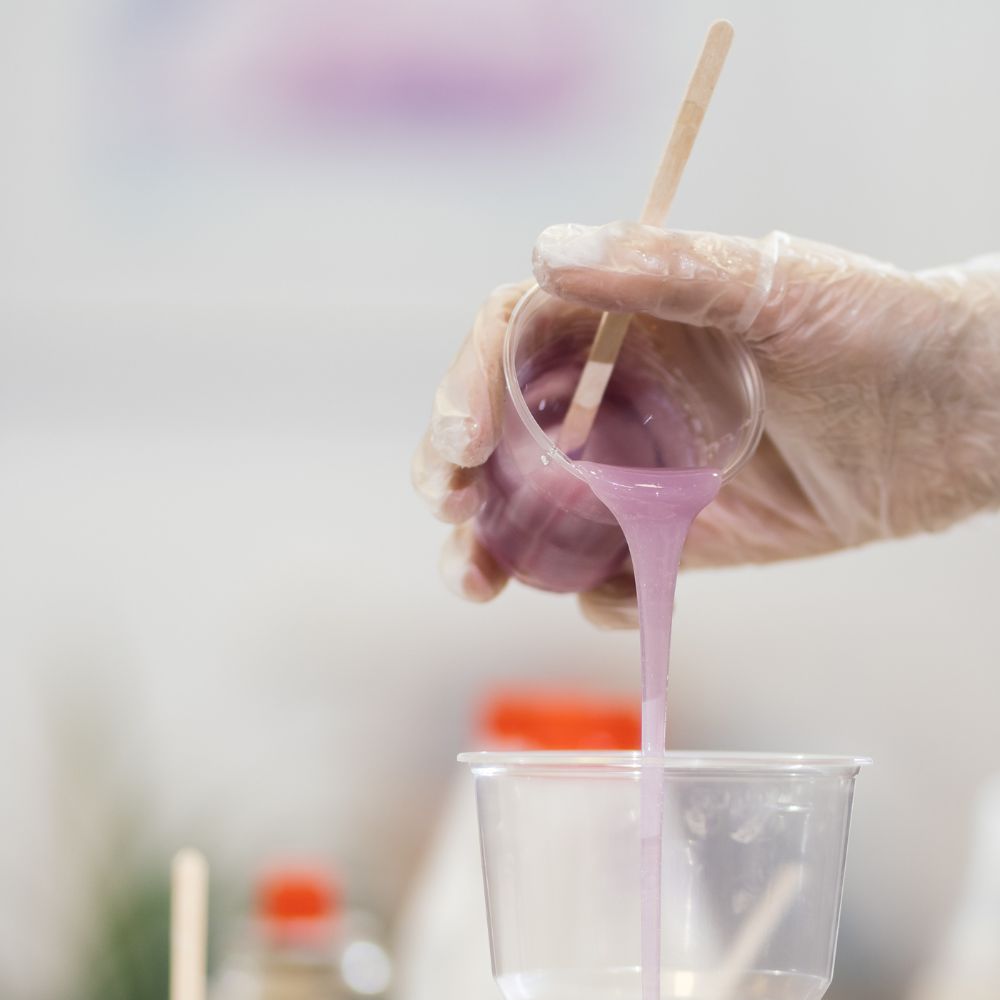 pouring purple resin to make an artisan keyring