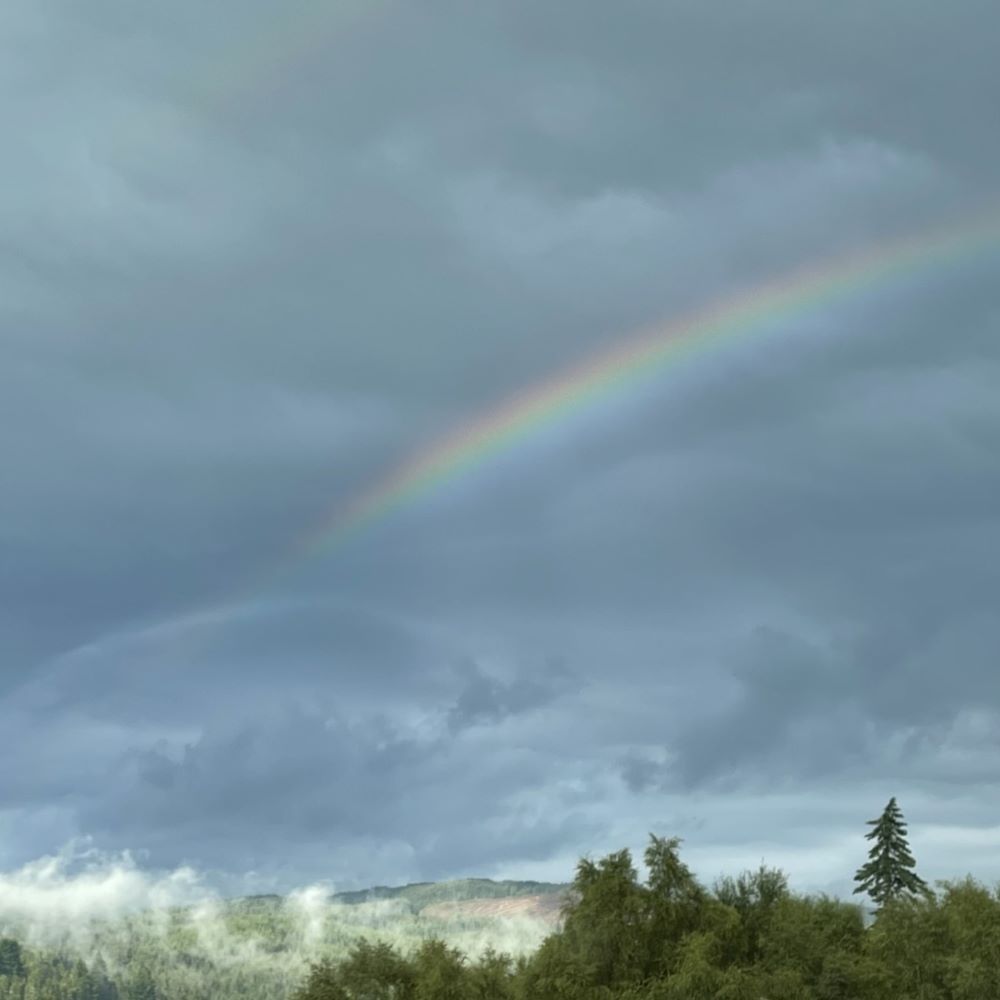Rainbow in cloudy highland skies
