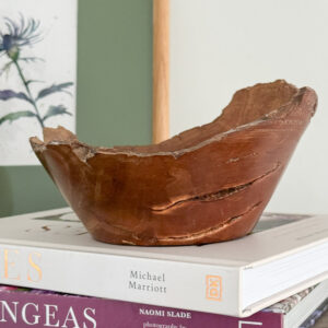 Elm Burr Bowl full or original character on a pile of books with an original Scottish Watercolour of a Scottish Thistle behind the bowl. Handmade in Scotland by Made in the Glen