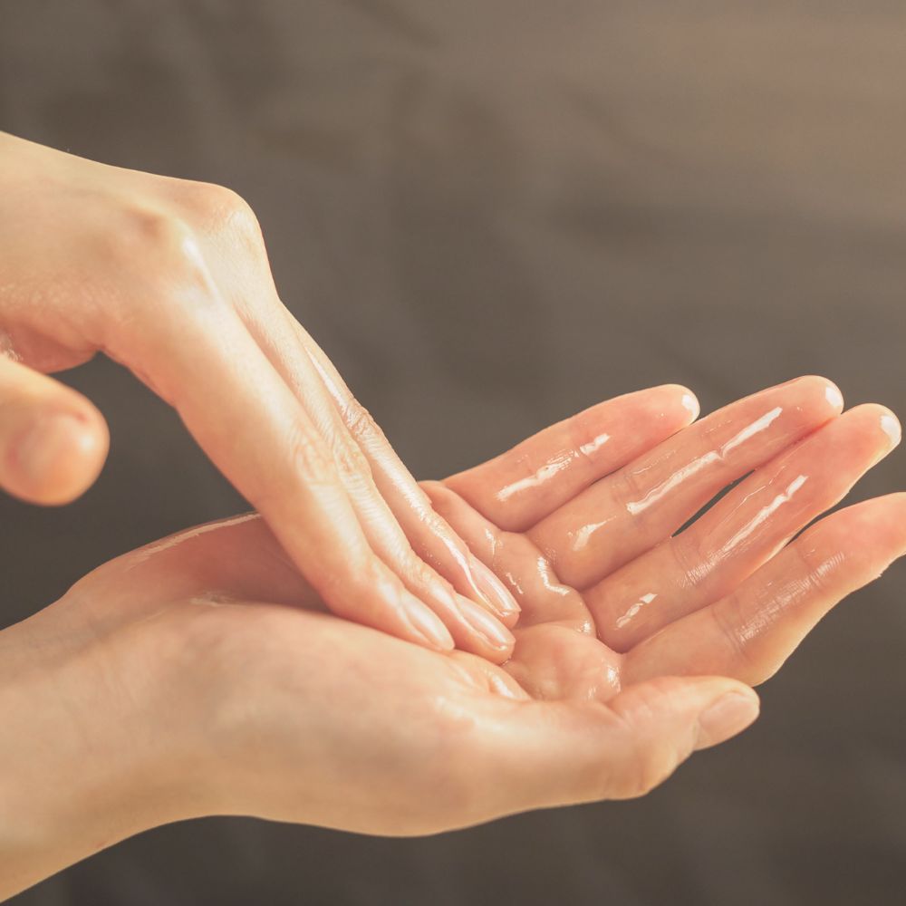 Balance oil cleanser in the palm of the hand ready to massage onto face