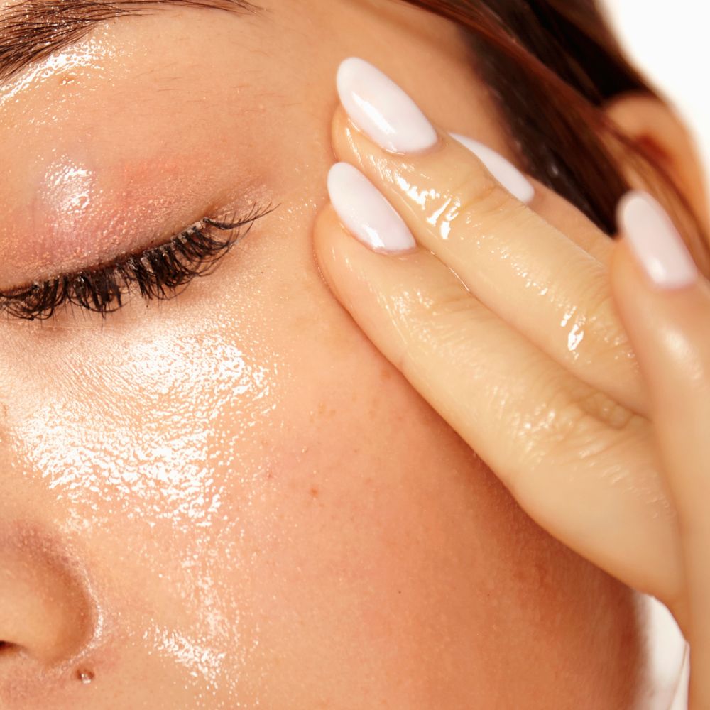 restore facial oil bing applied to a lady's face