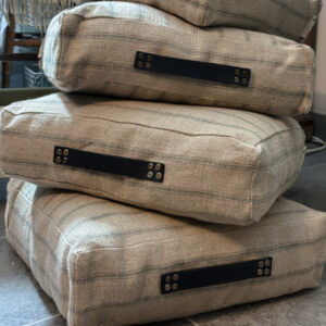 stack of floor cushions by Made in the Glen railroad stripe linen stuffed with British Wool and finished with blue leather handles