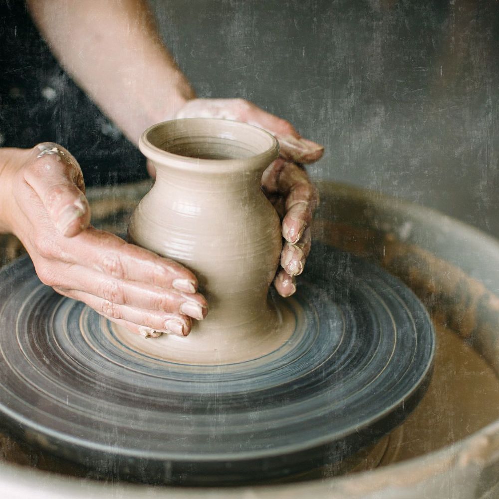 a potter throwing a vase on a potter's wheel. this shows how many of the traditional crafts are being kept alive in Scotland today