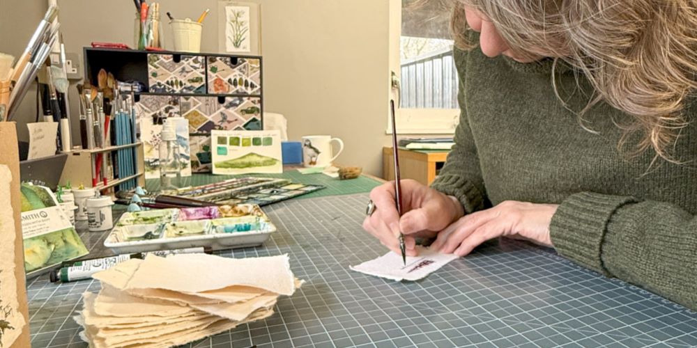 Julia in the art studio painting an original watercolour card