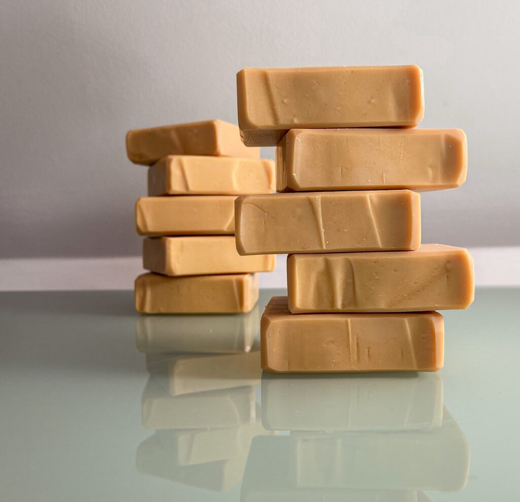 A stack of orange/pink coloured soap bars