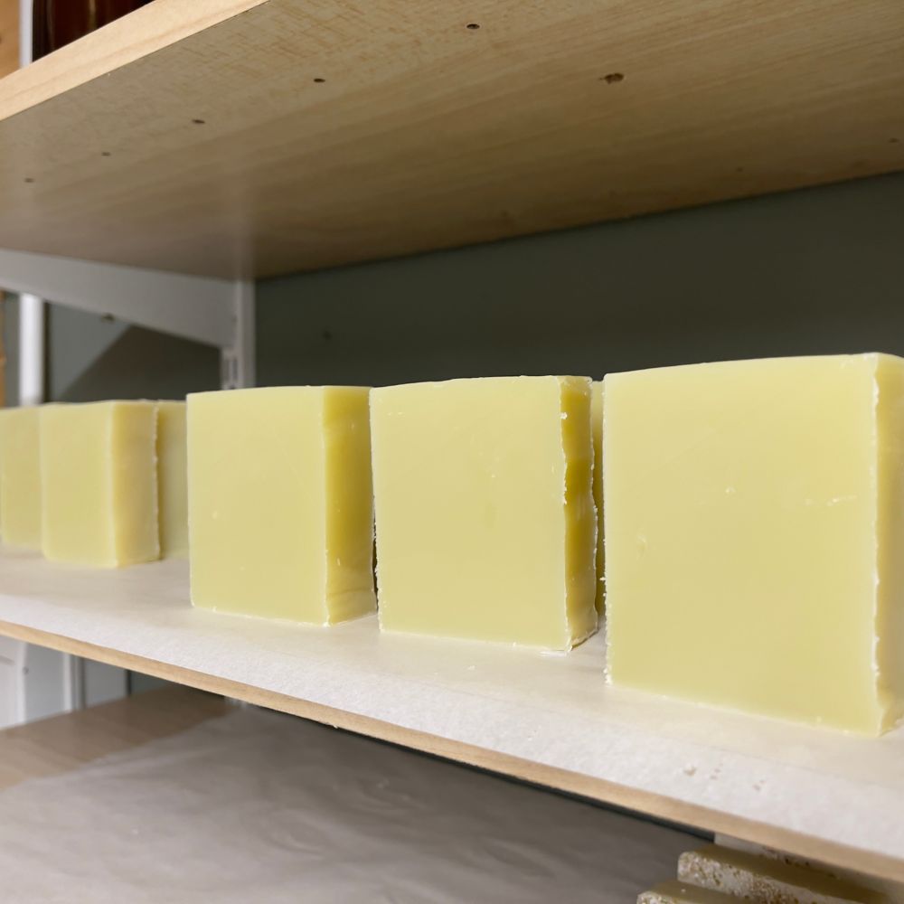 a row of floral body soaps curing on the shelves in the Made in the Glen lab