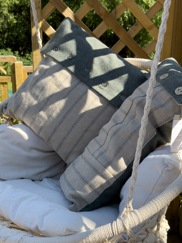 scottish linen and wool raidroad stripe heritage cushions in a garden swing in the sunshine springtime happiness vibes