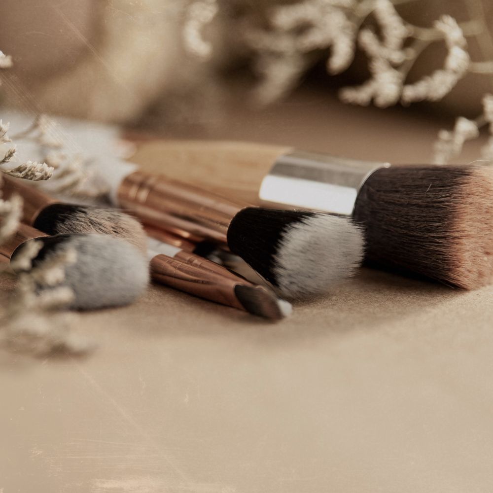 make up brushes laid out on a dressing table