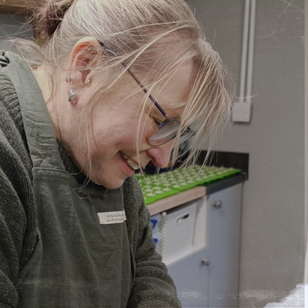 Elizabeth Griffin smiling as she make naked tealights in the Made in the Glen studio