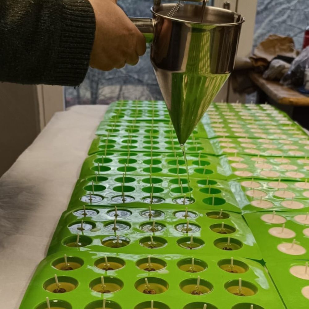 Elizabeth pouring hot soy was into moulds to make MITG naked tealights