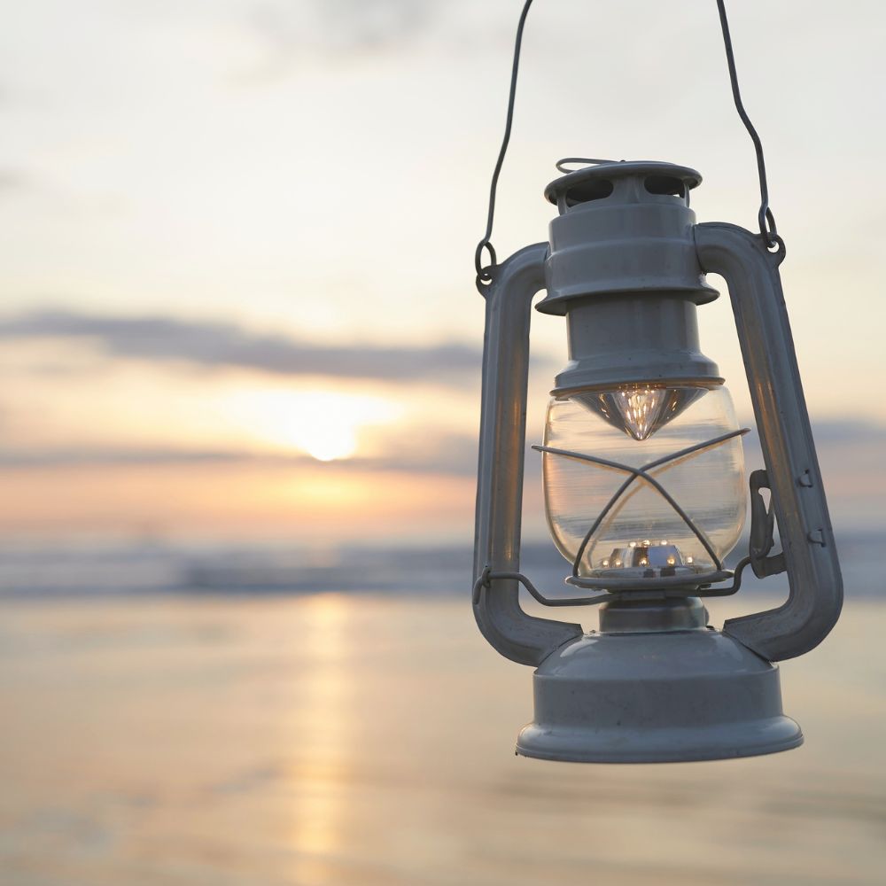 old fashioned paraffin lantern vintage lantern with a serene beach skyline in the background
