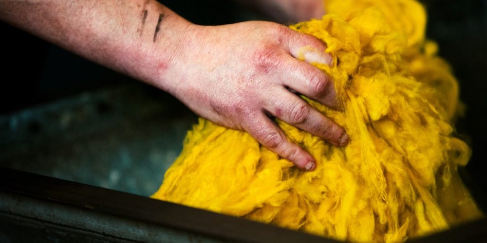 Man's hands washing the colour out of cashmere from the Todd & Duncan website